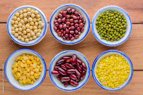 Various kinds of beans,different kinds of beans in bowl on wooden table.