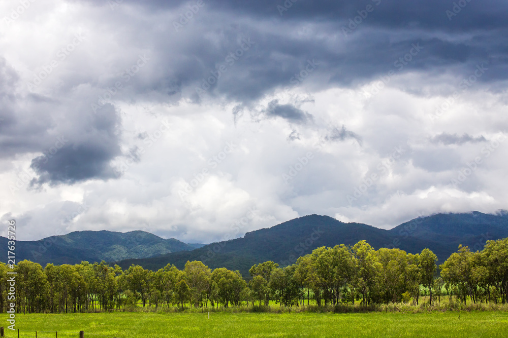 Storm clouds and rainforest covered hills on the Atherton Tablelands in Queensland, Australia