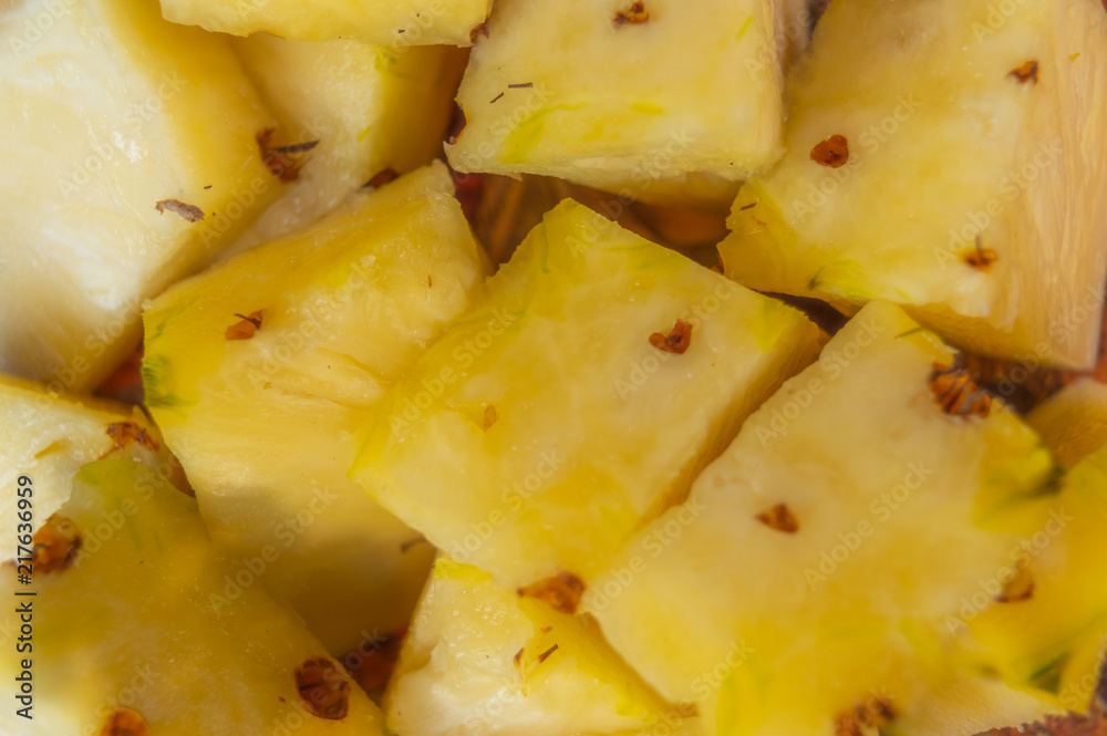 Ripe yellow pineapple slices kept on a plate ready to eat Ripe yellow pineapple slices kept on a plate ready to eat