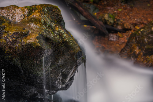 Waterfall flows over stone