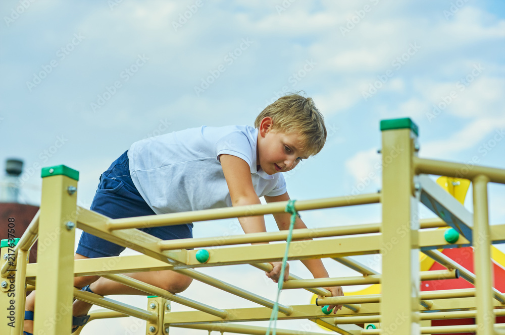 The boy plays on the Playground