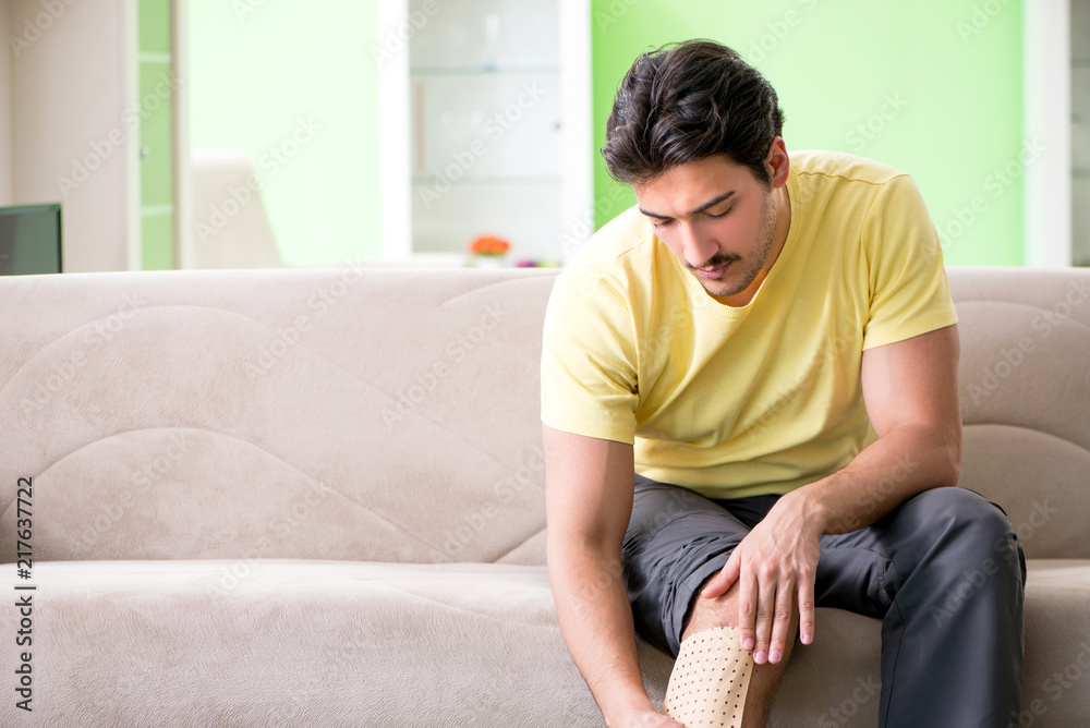 Man applying pepper Capsicum plaster to relieve pain Man applying pepper Capsicum plaster to relieve pain