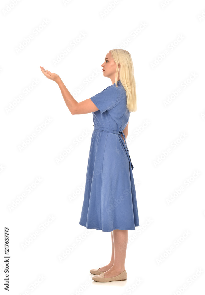 full length portrait of blonde girl wearing blue dress, standing pose. isolated on white studio background. full length portrait of blonde girl wearing blue dress, standing pose. isolated on white studio background.