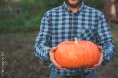 guy holding a pumpkin in her hands close-up