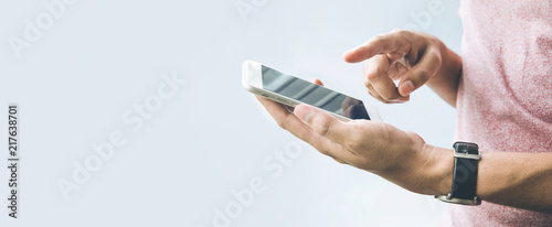 Male hand  holding smartphone,mobile with copy space on banner size  background.panoramic