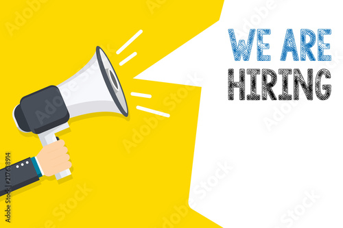 Hand holding megaphone with We Are Hiring text. Hand holding megaphone with open space for your text.
