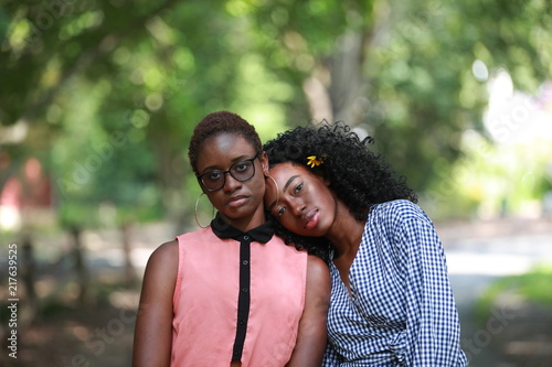 Clam ethnic women couple in park