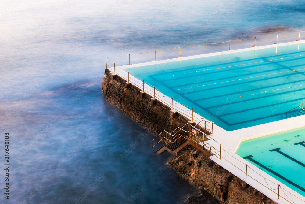 The edge of empty rock pool towards the ocean.