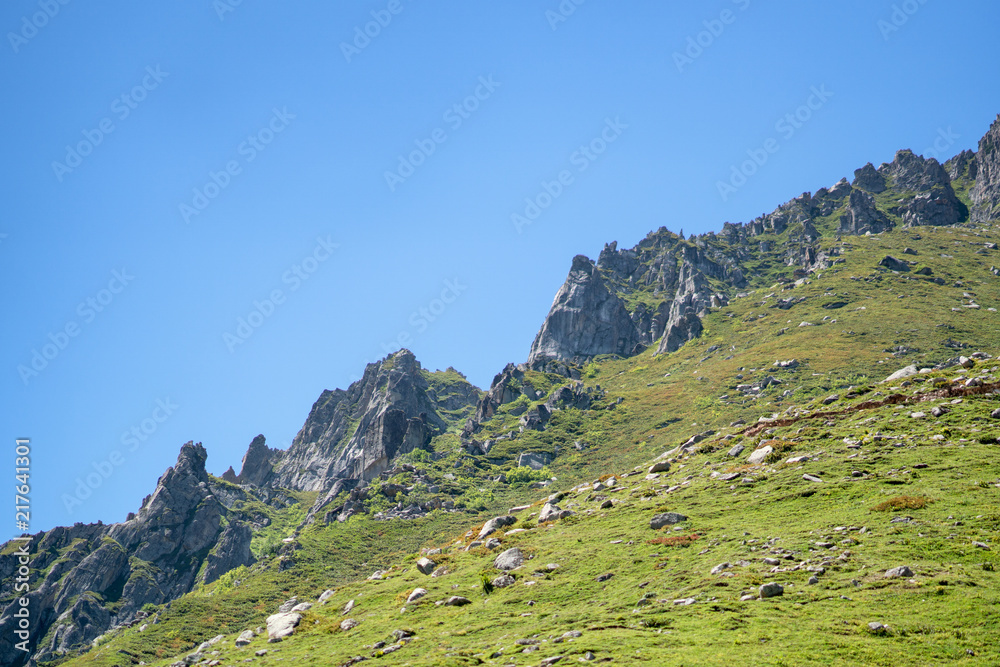 Beautiful mountain peak range with grass and rocks.