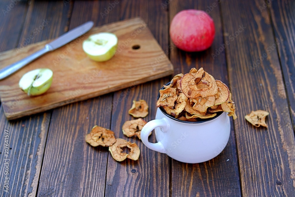 Dried organic apples in a white ceramic cup. Harvest processing of apples.