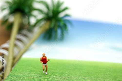Miniature people : marathon runners with The Beach Sea , jogging and running,healthy lifestyle and sport concepts.