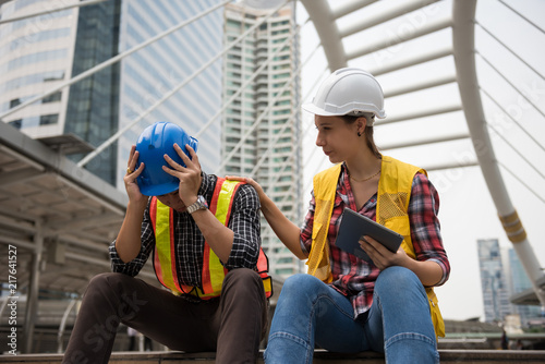 Sad Asian engineer in city