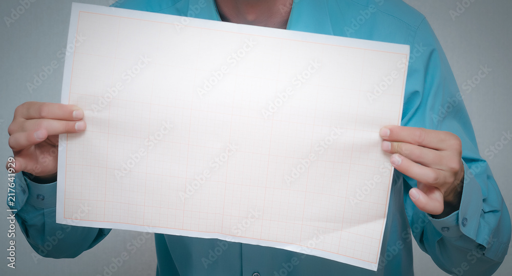 Man is holding in hand a plan draft document isolated on gray background. Man is holding in hand a plan draft document isolated on gray background.