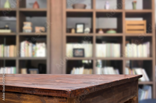 Wooden board empty table space platform in front of blurred library Of The background - can be used for display or montage your products. Mock up for display of product.