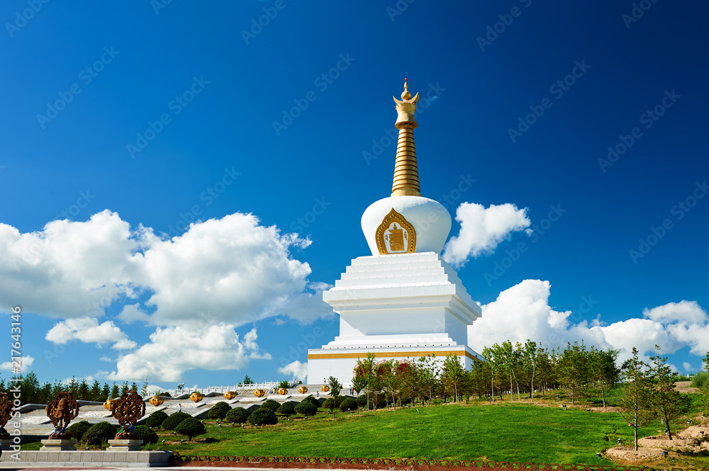 The white pagoda in blue sky and white clouds