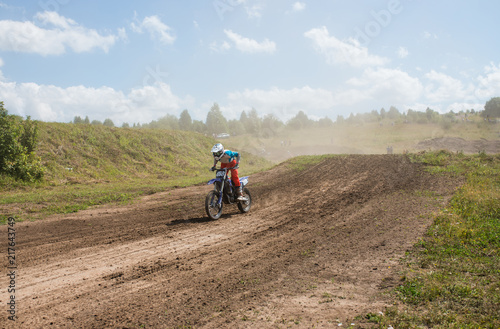 A picture of a biker doing a trick, and jumping into the air. Motocross Championship. sports fast driving. bike large small.