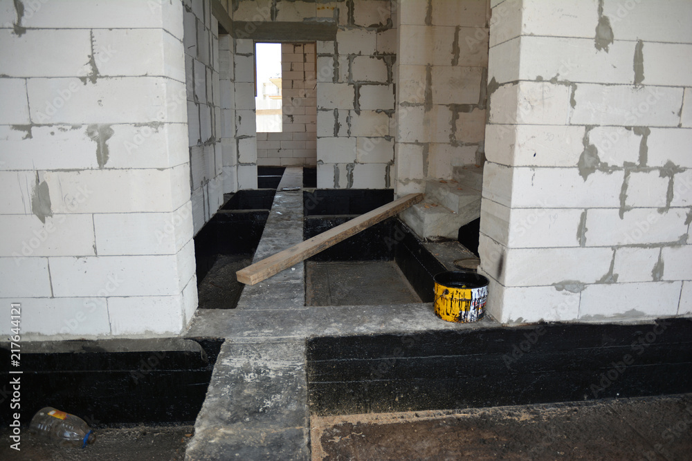 Foundation bitumen waterproofing. Building house construction with