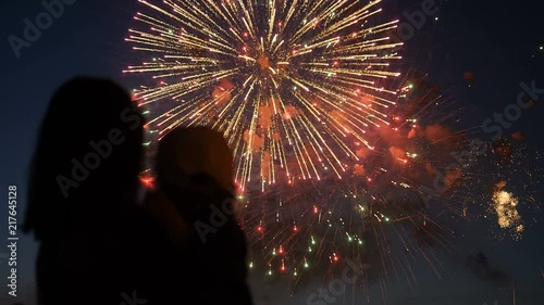 Mother and daughter watching fireworks.