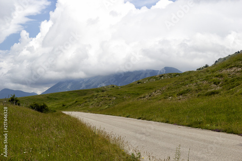 view of mountain road and clouds