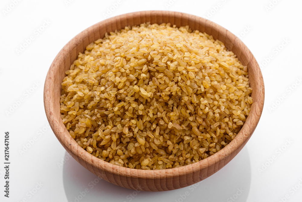raw bulgur on a white acrylic background raw bulgur on a white acrylic background