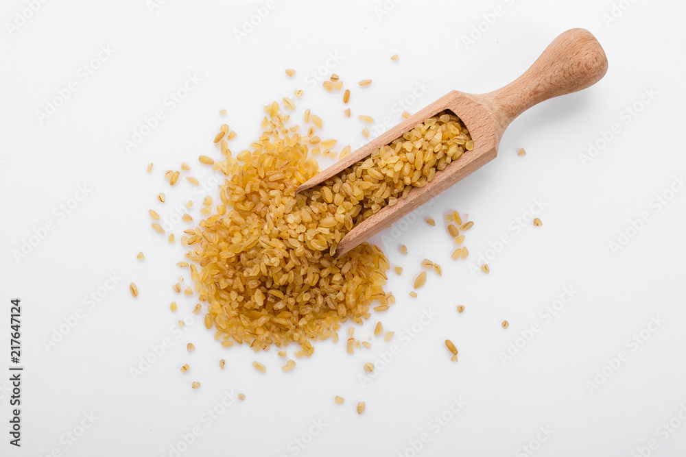 raw bulgur on a white acrylic background raw bulgur on a white acrylic background