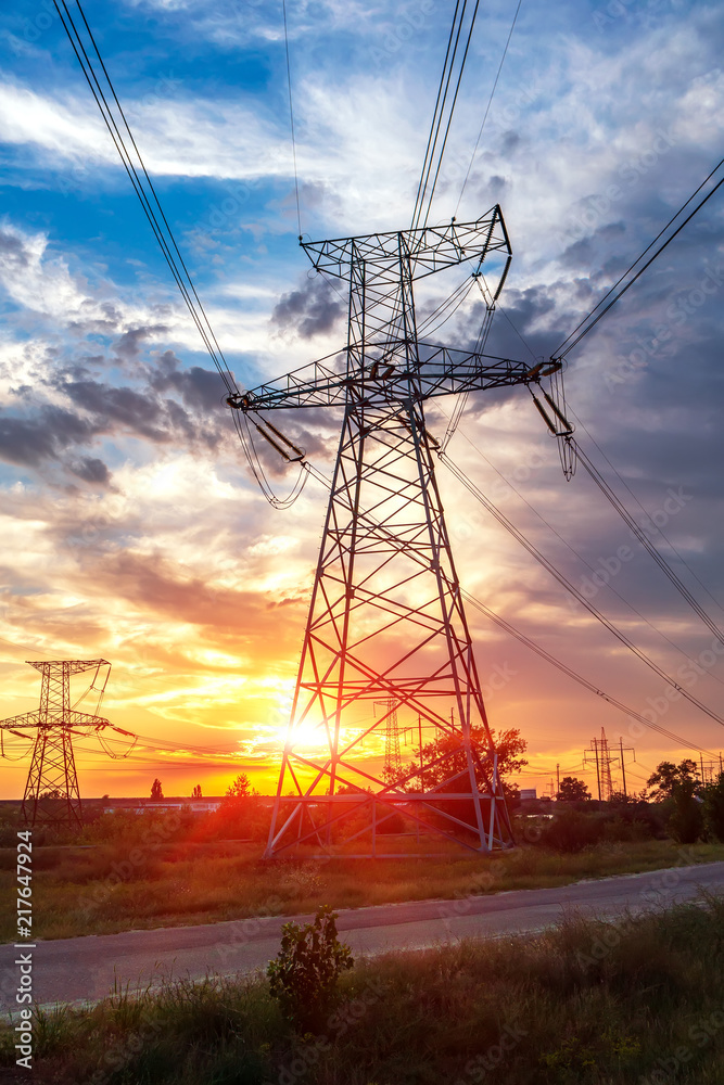 High power electricity poles in urban area. Energy supply, distribution of energy, transmitting energy, energy transmission, high voltage supply concept photo.