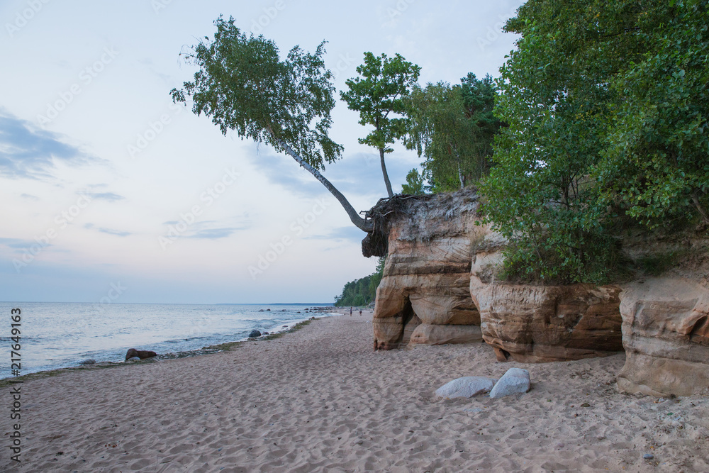 Baltic sea with waves, rocks and blue sky. Summer evening.