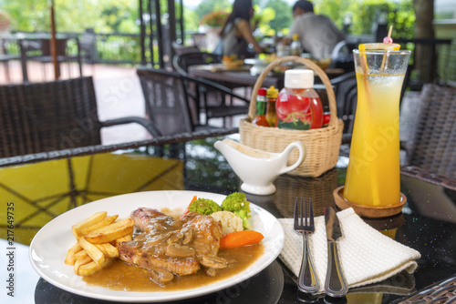 Juicy grilled pork steak and potatoes vegetables for restaurant menus healthy eating homemade with mushroom sauce on wooden table.