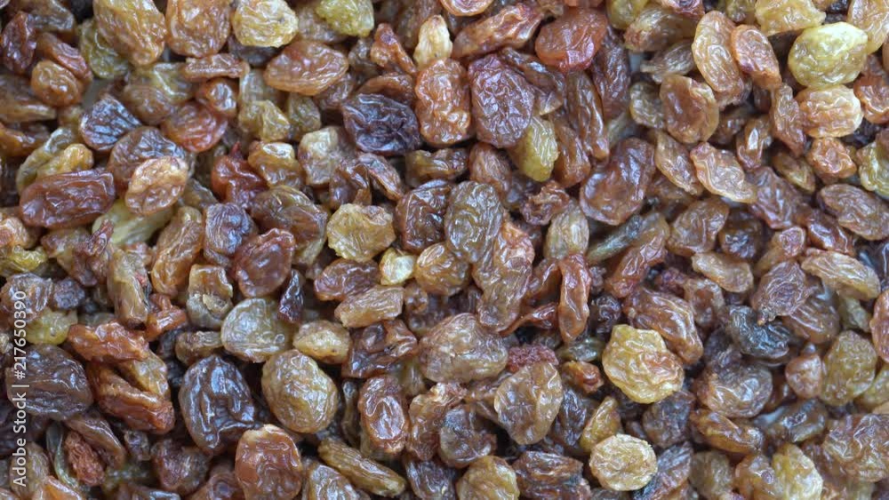 Pile raisins background, close up rotation loopable 4k top view. Food background. Gastronomy concept, organic food. Macro dry raisins Pile raisins background, close up rotation loopable 4k top view. Food background. Gastronomy concept, organic food. Macro dry raisins
