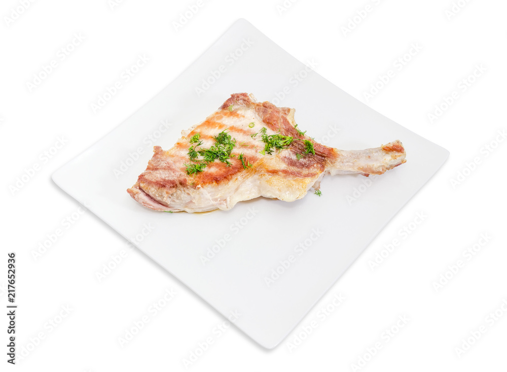 Grilled pork loin chop on white square dish Grilled pork loin chop on white square dish