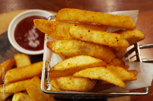 Close up of French fries on wooden table