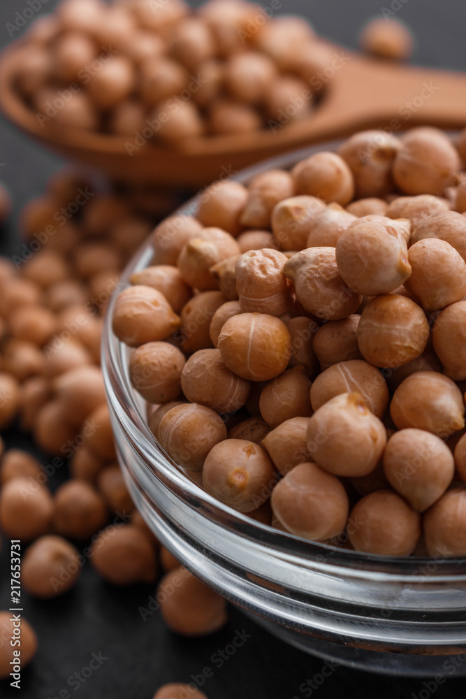 uncooked chickpeas on a dark stone background uncooked chickpeas on a dark stone background