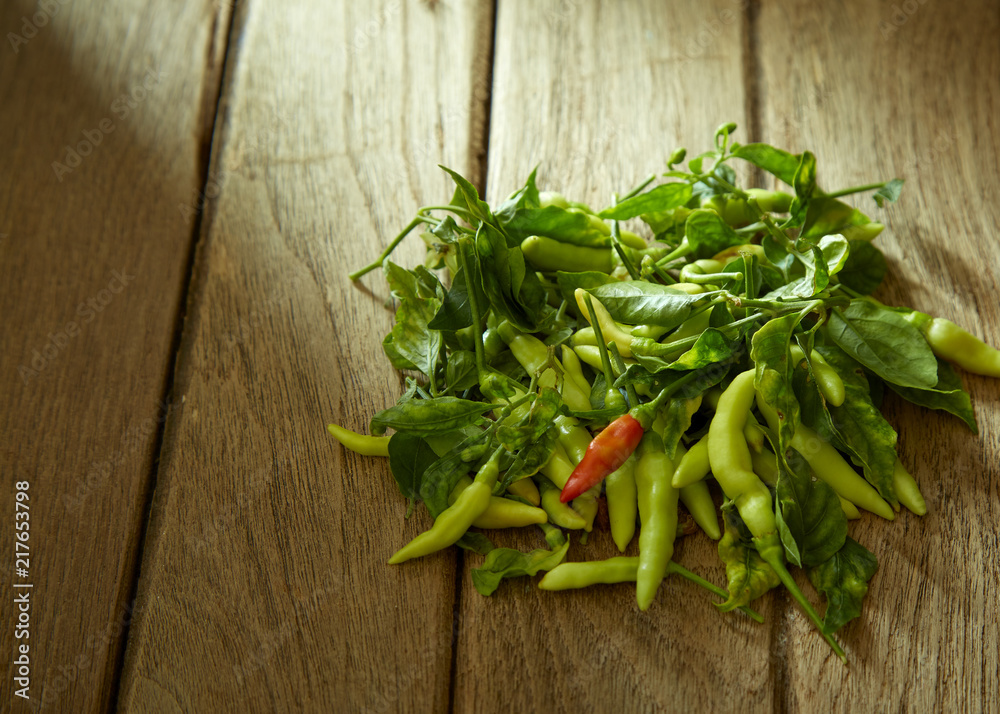 One Red chili pepper in green peppers One Red chili pepper in green peppers