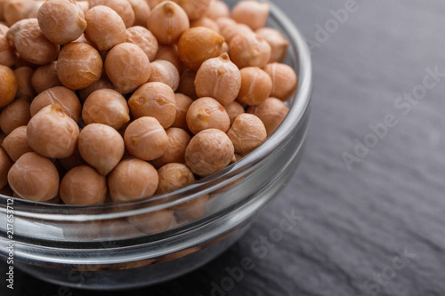 uncooked chickpeas on a dark stone background