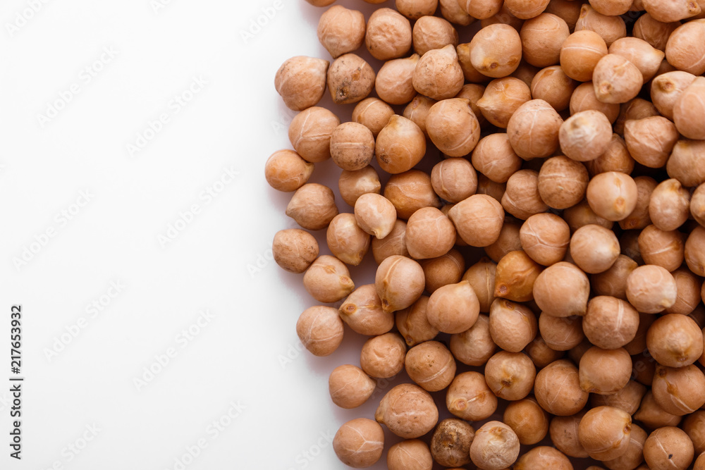 uncooked chickpeas on a white acrylic background uncooked chickpeas on a white acrylic background