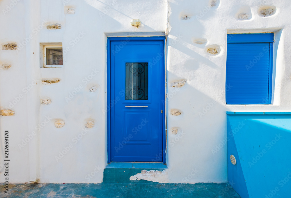 Blue wooden door and window in old stone house Blue wooden door and window in old stone house