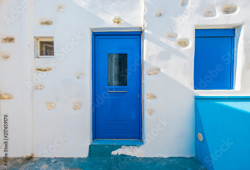Blue wooden door and window in old stone house