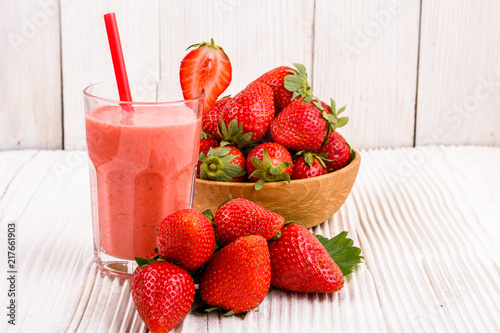 fresh strawberrysmoothie or milkshake on a wooden rustic background photo