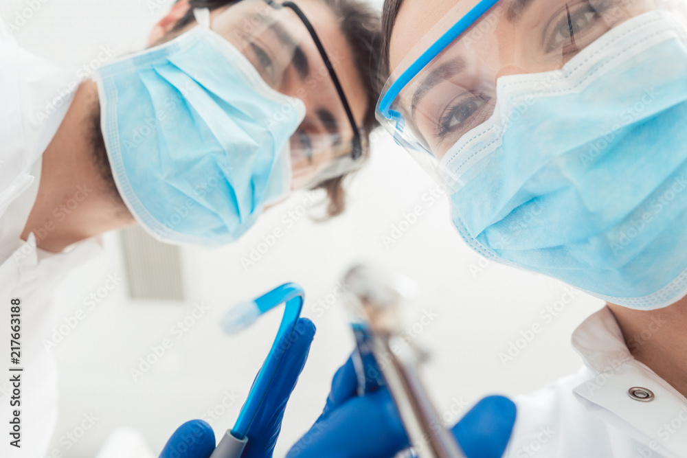 Funny dentists with their tools from point of view being a bit dangerous Funny dentists with their tools from point of view being a bit dangerous