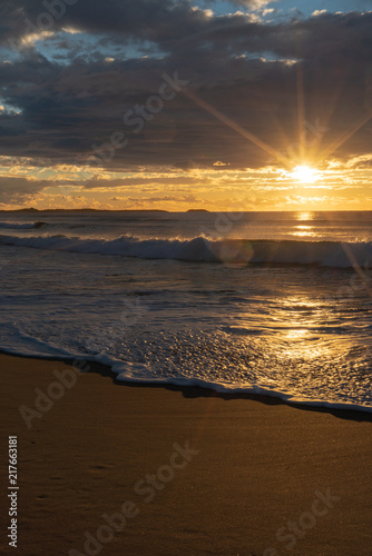 Sunrise sunburst over the ocean photo