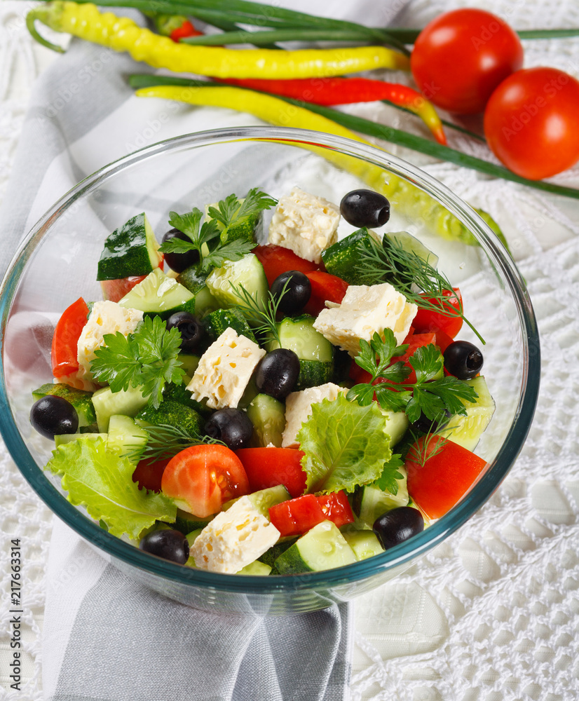 Salad of fresh vegetables and cheese on served table Salad of fresh vegetables and cheese on served table