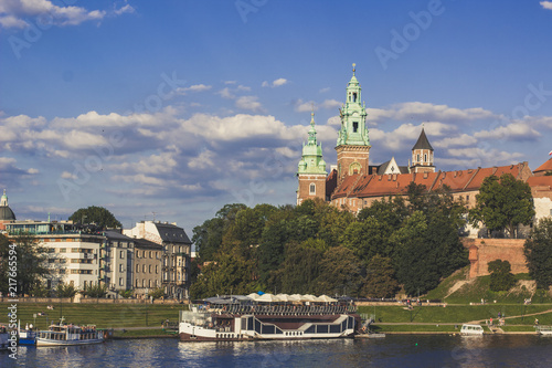 architecture and tourism for wallpaper concept of medieval beautiful castle near river in waterfront old city district in bright colorful day time on blue sky background