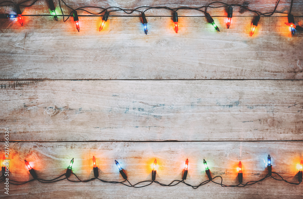Vintage Christmas lights bulb decoration on old wood plank. Merry Christmas and New Year holiday background. vintage color tone.