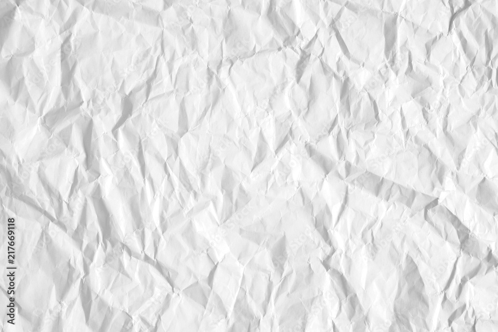 Texture of white crumpled white paper with kinks and dents. Flat lay, top view, copy space 
