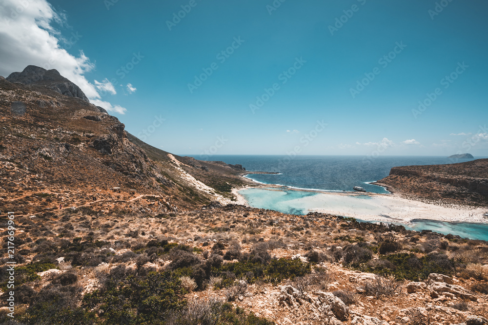 View of the beautiful beach in Balos Lagoon, and Gramvousa island on Crete, Greece. Sunny day, blue Sky with clouds.