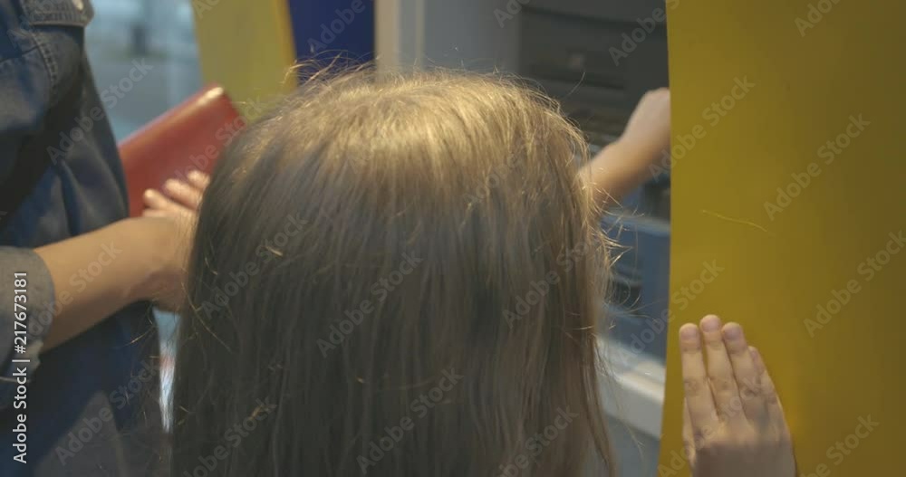 Young mother and her little preteen daughter using an ATM together Stock Video | Adobe Stock