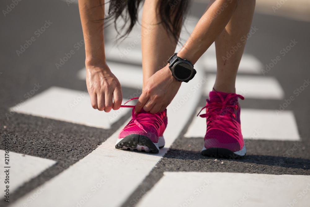 Healthy lifestyle fitness woman runner tying shoelace Healthy lifestyle fitness woman runner tying shoelace