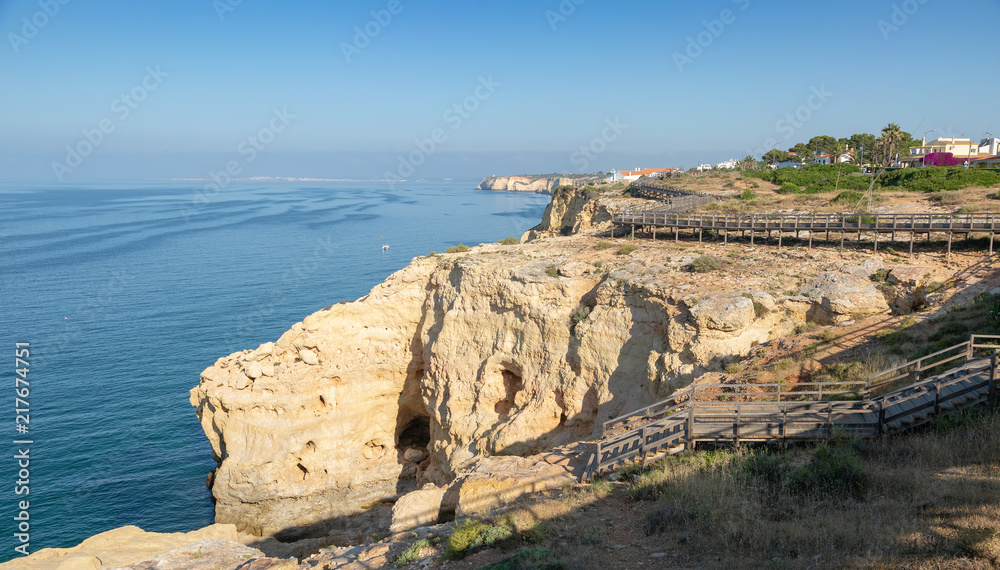 Wooden boardwalk running along the cliff top at Carvoeiro Wooden boardwalk running along the cliff top at Carvoeiro