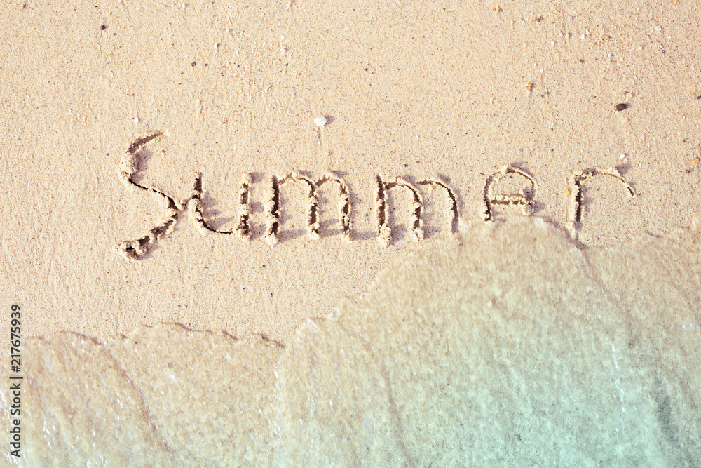 Summer written in the sea sand.
