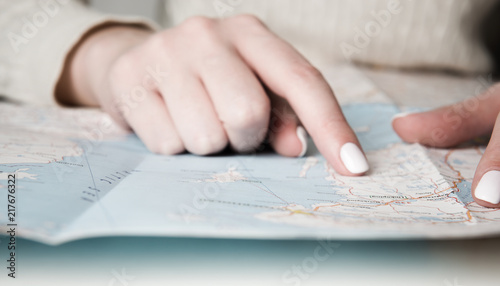 Female finger on map